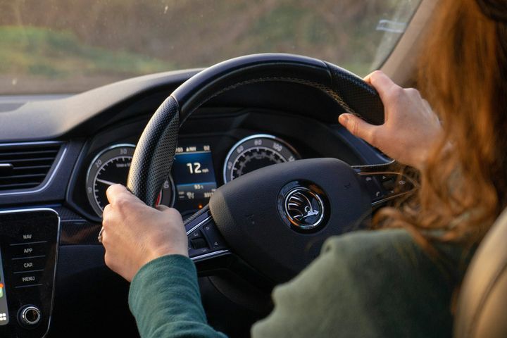 Driver with both hands on the wheel during a lesson