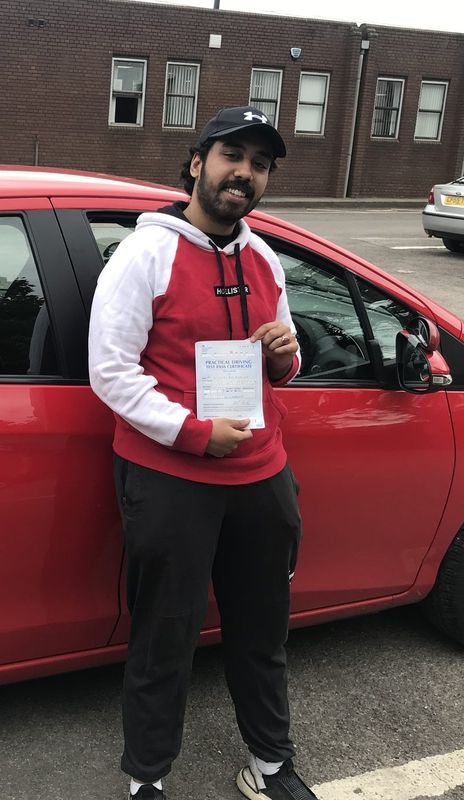 Driving school student holding their driving test pass certificate