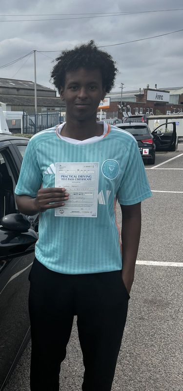 Driving school student holding their driving test pass certificate